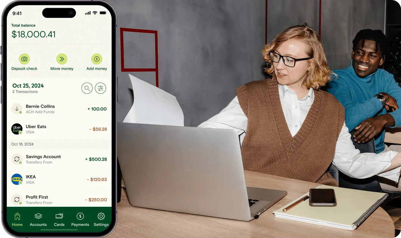 A man and a woman working together on something with a phone graphic on the left